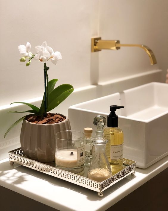 Antique silver tray filled with amenities for guests in a powder room