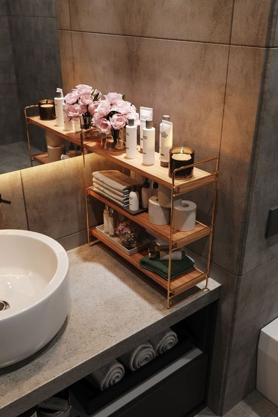 bathroom counter organiser with 3 wooden shelves and bathroom supplies. 