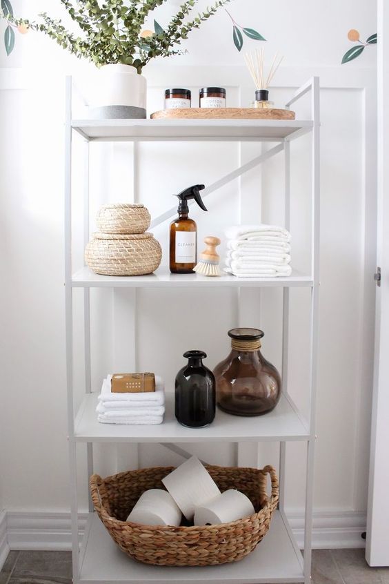 guest bathroom white shelving unit stocked with supplies