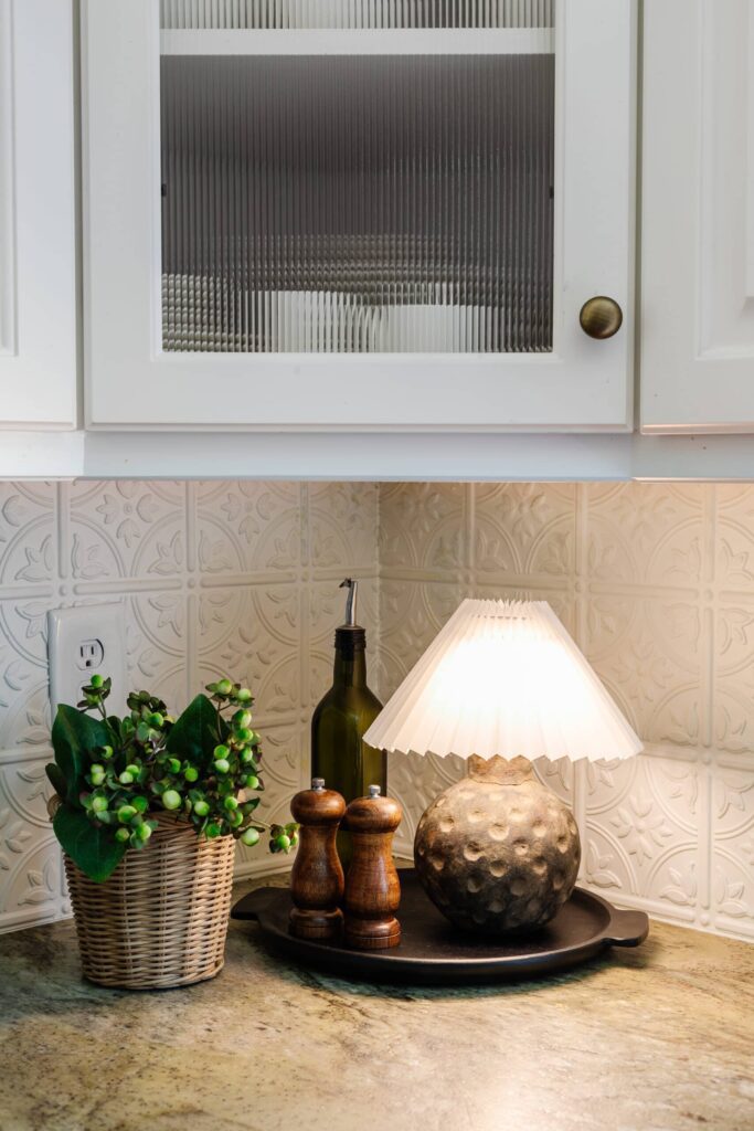 small ceramic lamp on top of a marble kitchen counter