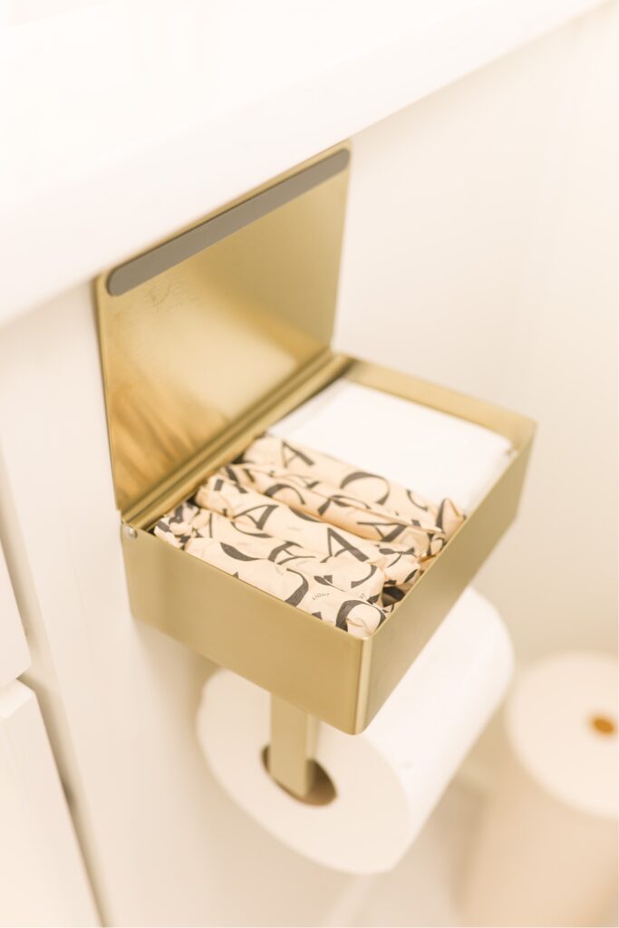 gold wall-mounted toilet holder with storage box on top for wipes and feminine products