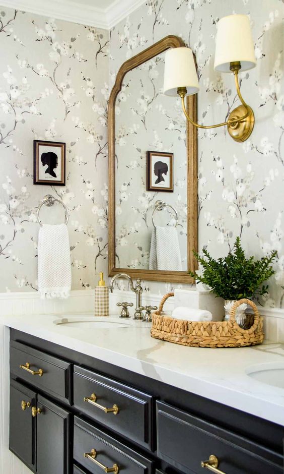 classic bathroom with vintage flower wallpaper, gold mirror and marble countertops