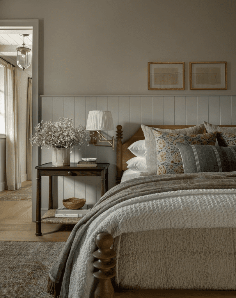 Cottagecore bedroom with classic golden wall-mounted sconces by the bed