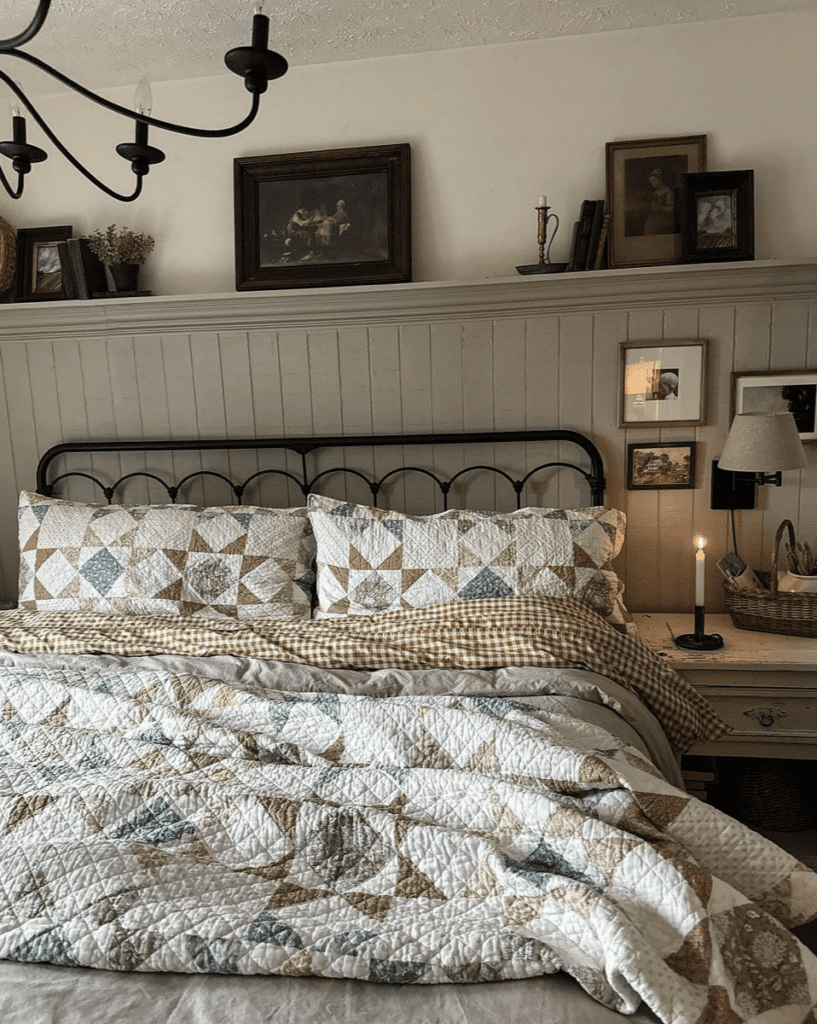 Cottage bedroom with a beautiful quilt laying on a bed with metal vintage frame