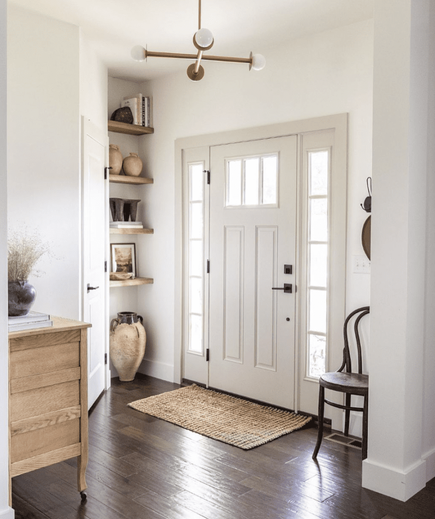 Picture shows country-style entryway to present decor on both sides of the entrance door