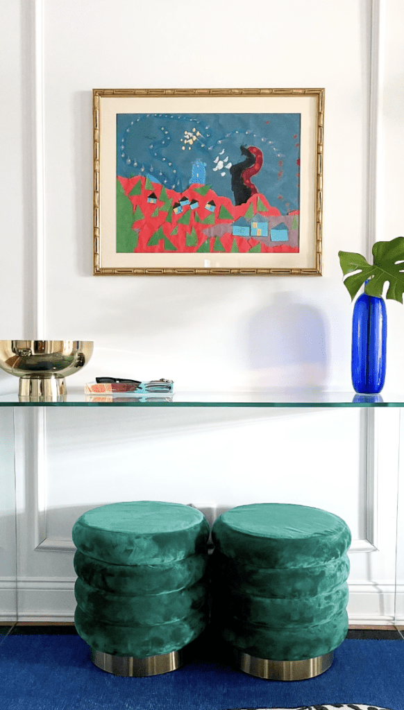 Picture illustrates how to use a clear glass console table to add a modern element of decor to a small entryway