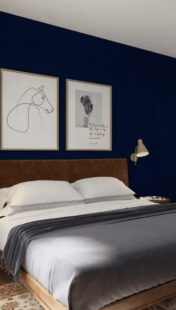 blue accent wall in a modern mid century bedroom