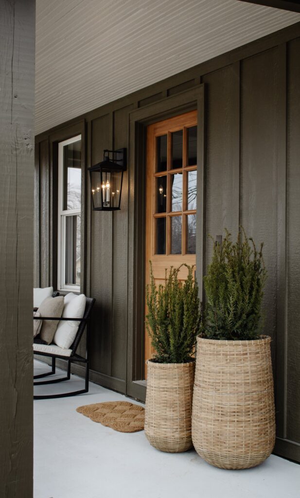 tall rattan planters used to decorate a modern minimalistic entrance