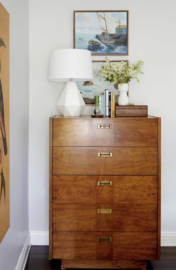 mid century vintage woo dresser with gold handles used for bedroom decor