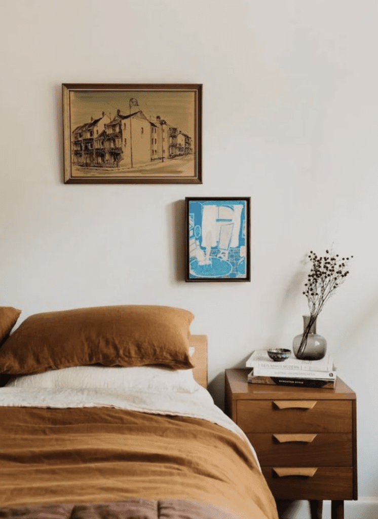 Vintage prints used for a small mid century gallery wall on top of a classic bed