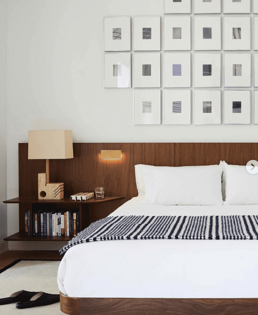 mid century bedroom with wood accent wall behind the bed