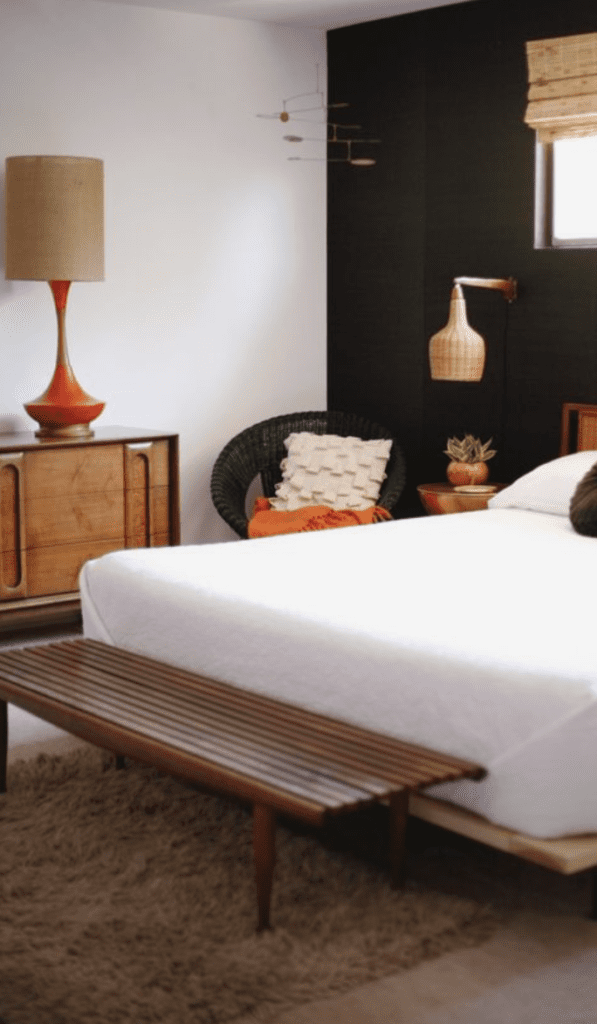 Wooden vintage bench at the end of the bed for a timeless bedroom