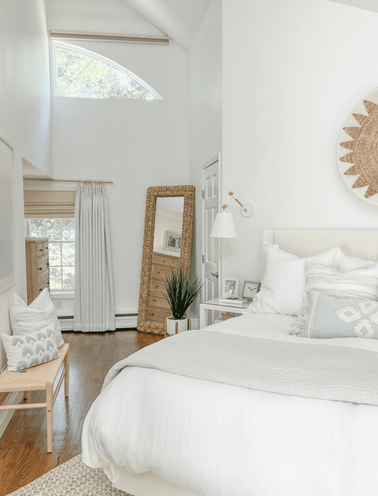 all-white bedroom with few beige and light blue accent pieces