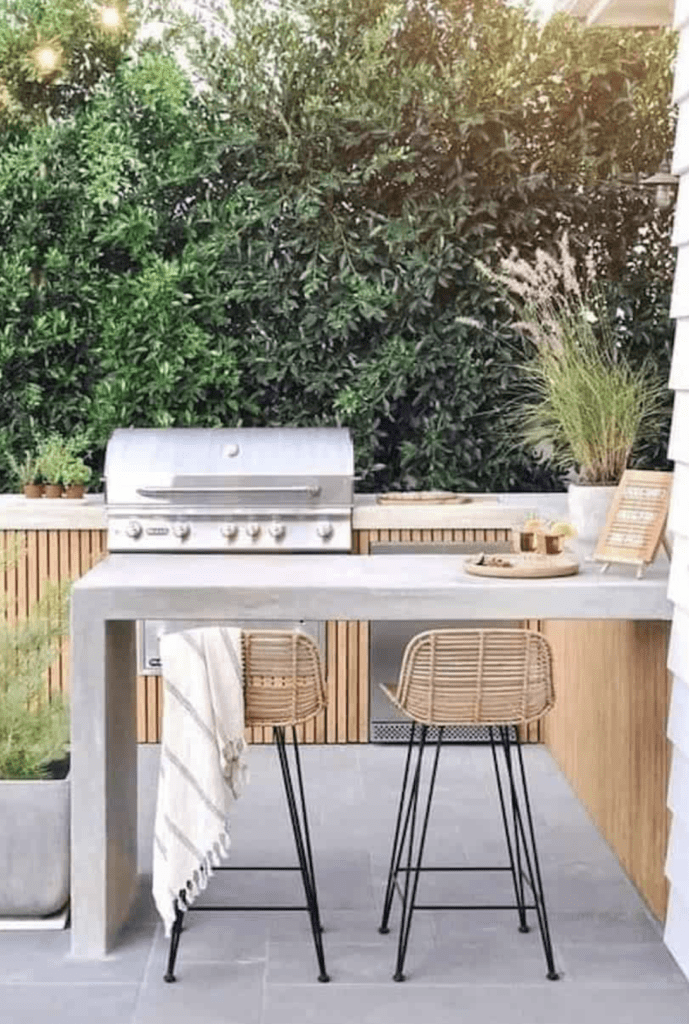 bar counter with wicker stools for outdoor kitchen