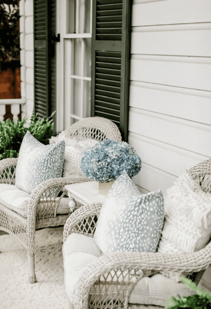 small front porch with wicker chairs and modern printed pillows