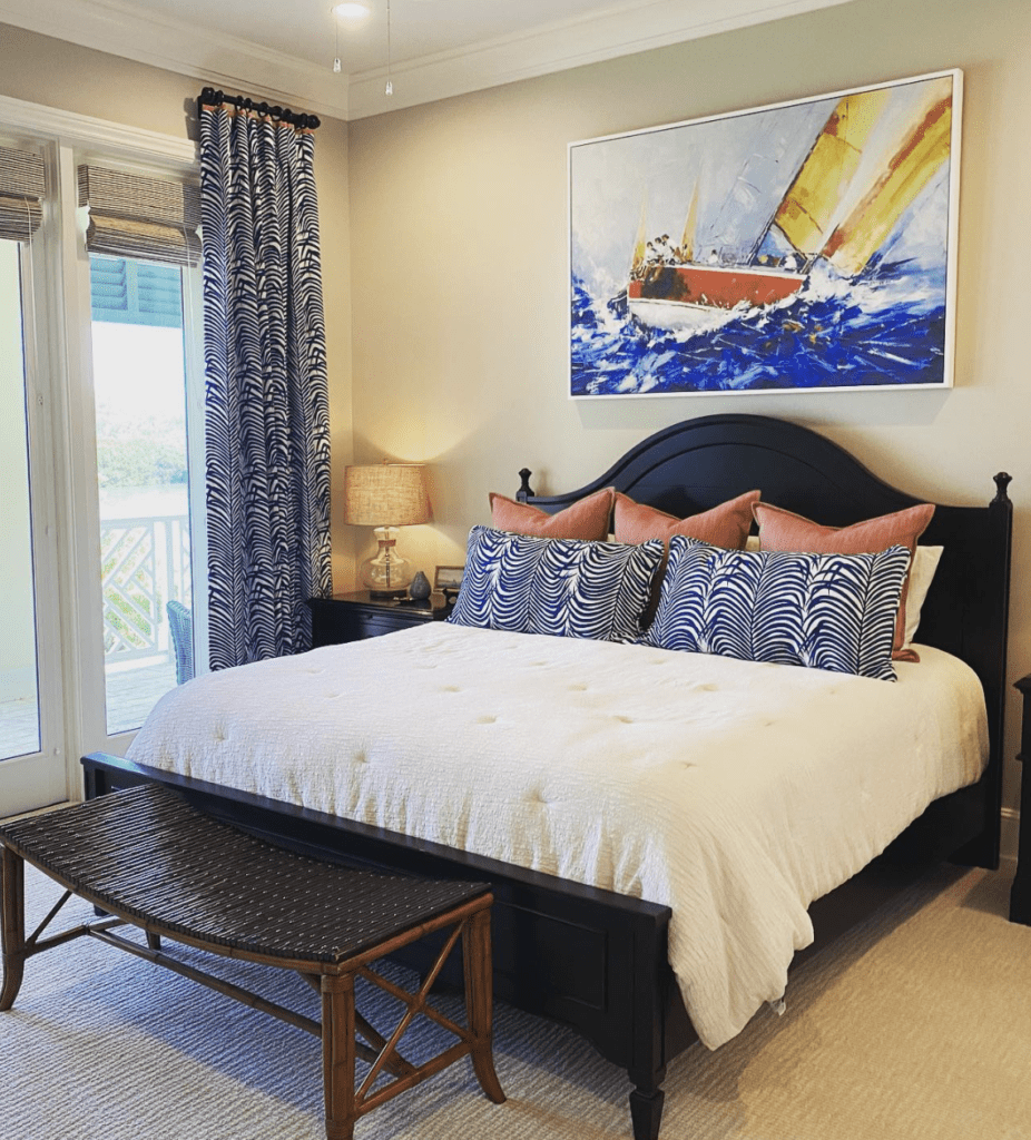 Traditional costal bedroom with large sea-inspired art as above-bed decor