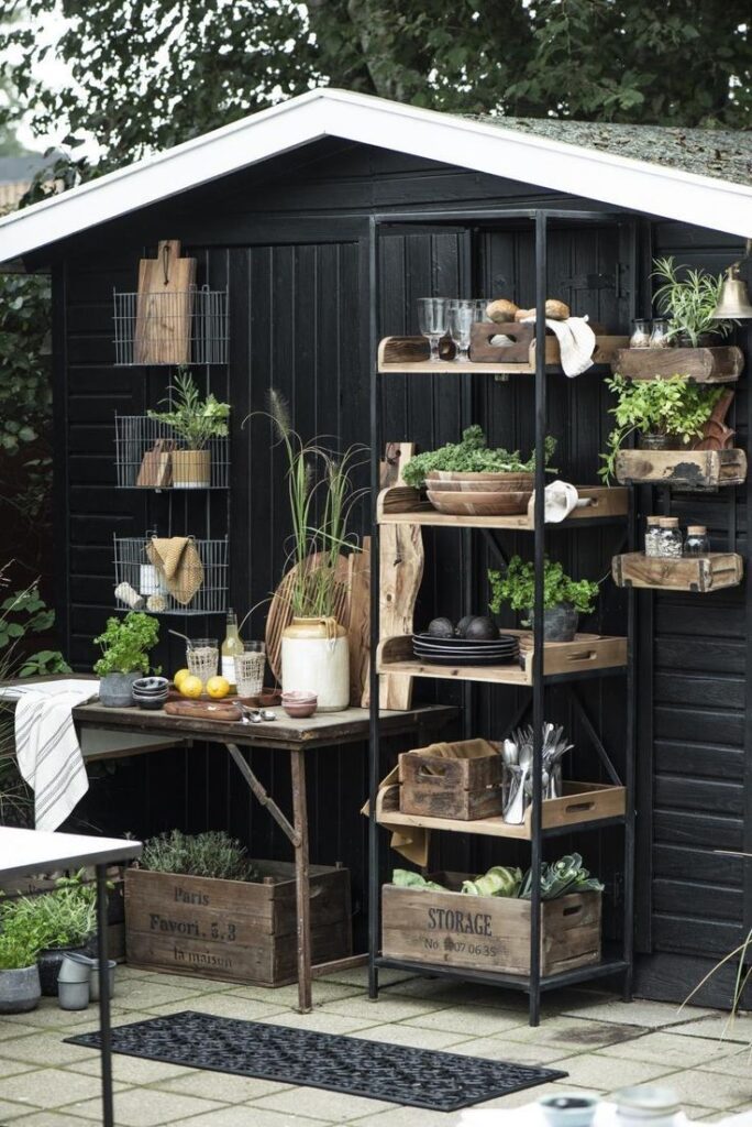 black small outdoor kitchen with metal shelving unit