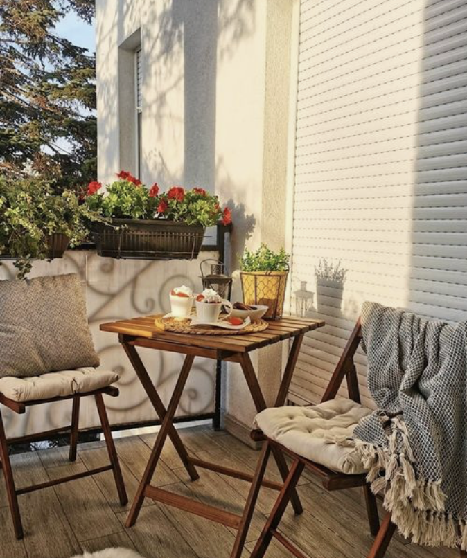 small front porch with wood table set and blanket