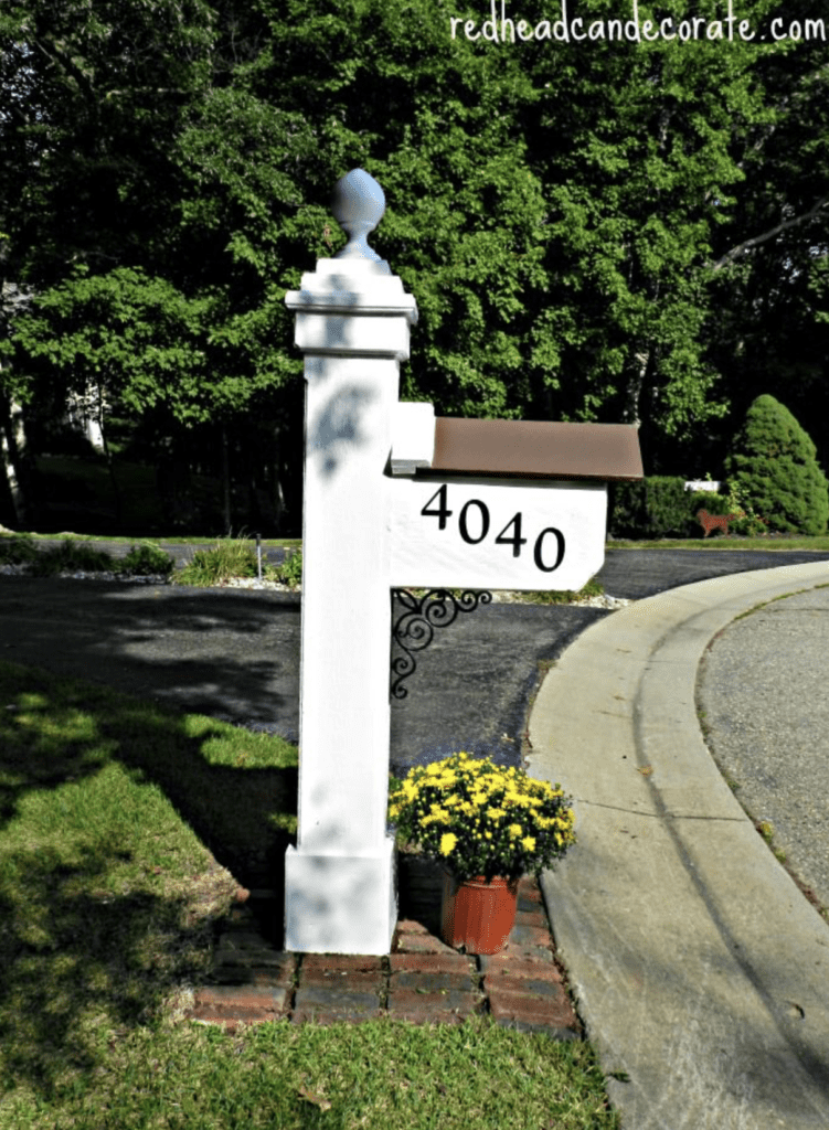 Single flower pot on red brick base used to decorate a mailbox