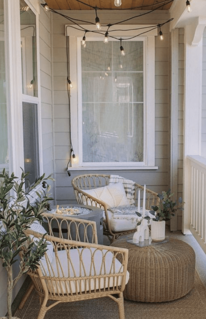 modern small front porch ideas that incorporate fire pit and string lights