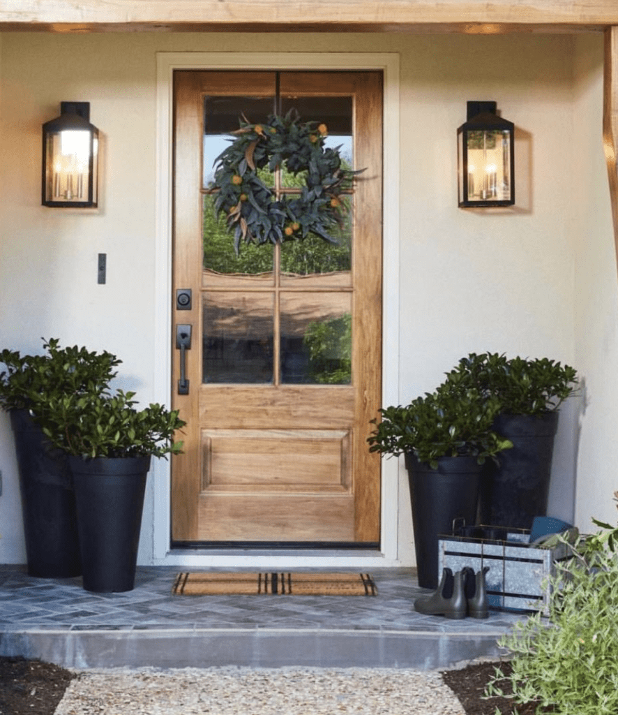 small front porch with tall planters and disguised storage