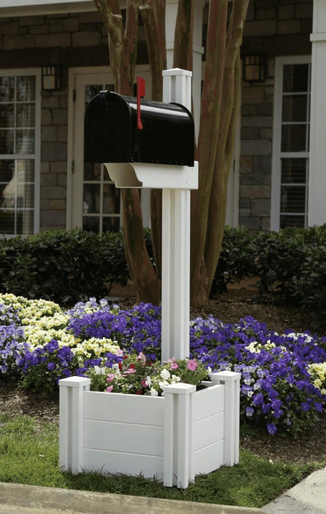 mailbox post with planter in classical style with colorful flowers for contrast 