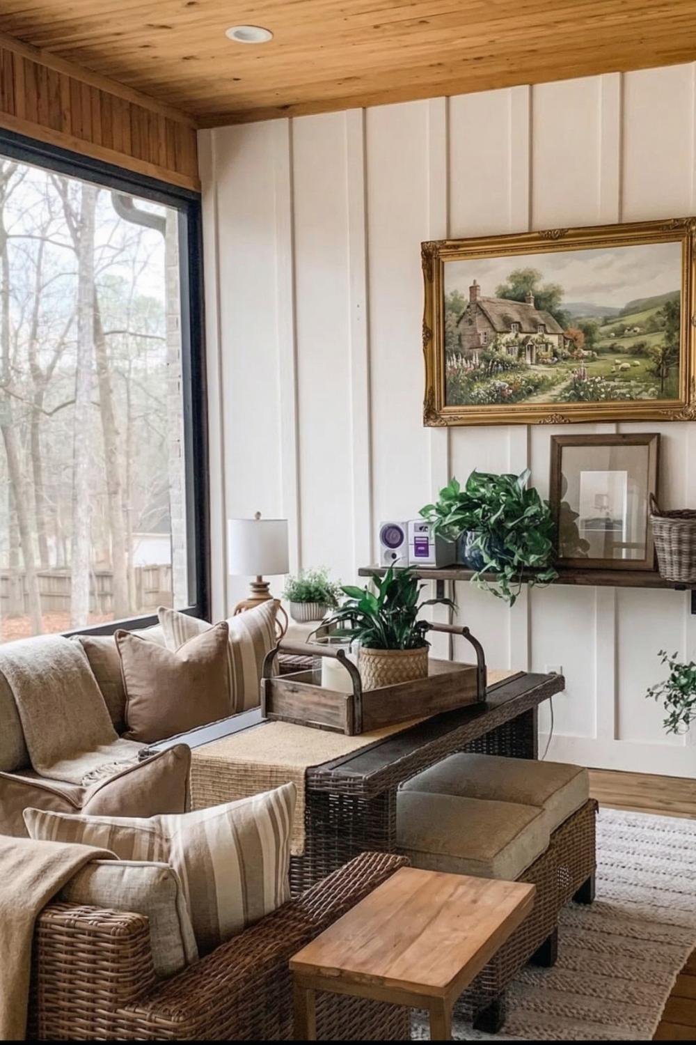Enclosed cottage porch idea with a brown wicker sectional, neutral striped pillows, and warm wood-paneled ceiling.