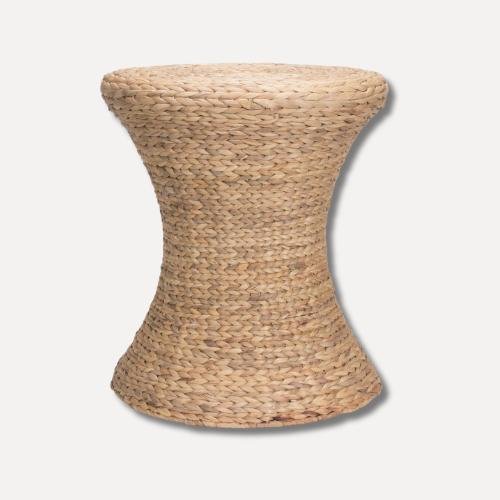 Natural woven wicker stool with an hourglass silhouette, featuring a braided texture and gently flared top and base on a plain background.